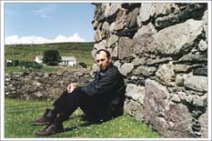 Jim sitting agains wall of 12th century church Jim sitting agains wall