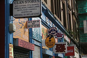 Photo: Multiple signs outside shop.