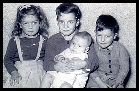 Photo: John holding Roger with Catherine and Danny.