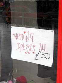 Photo: Sign: Wedding dresses  only 50 pounds.