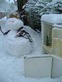 Photo: Snow man having a drink.