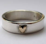 Photo: silver ring with gold heart.
