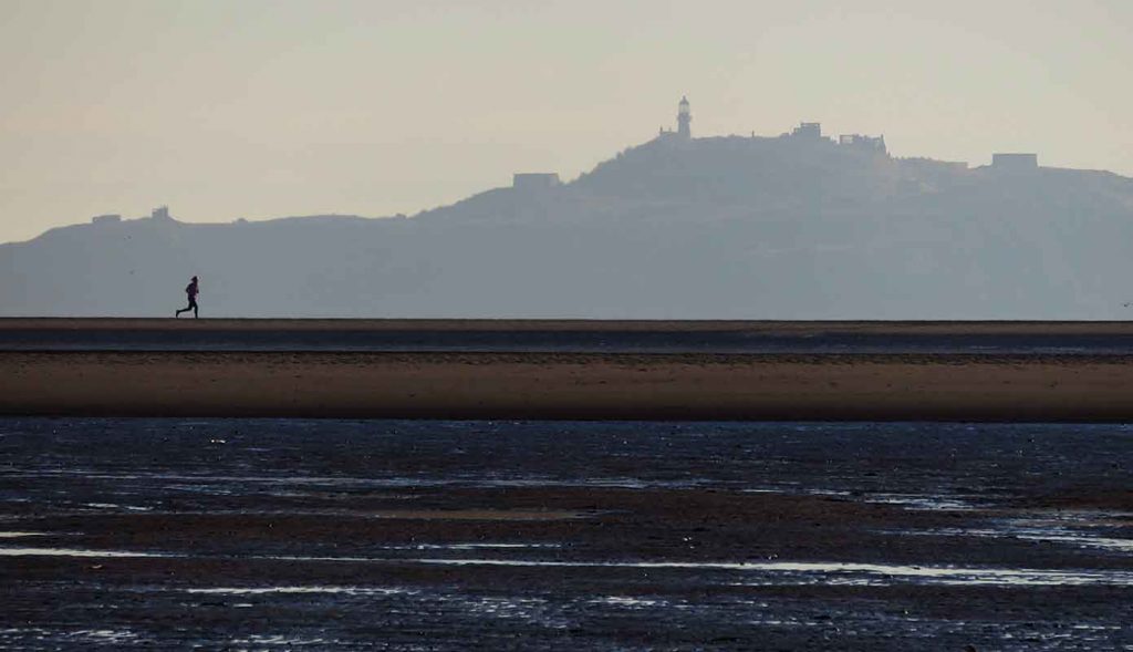 Jogger and Inchkeith. Burntisland Sands