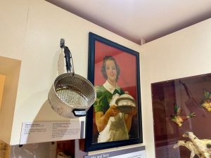 Woman with dish in kitchen 50s