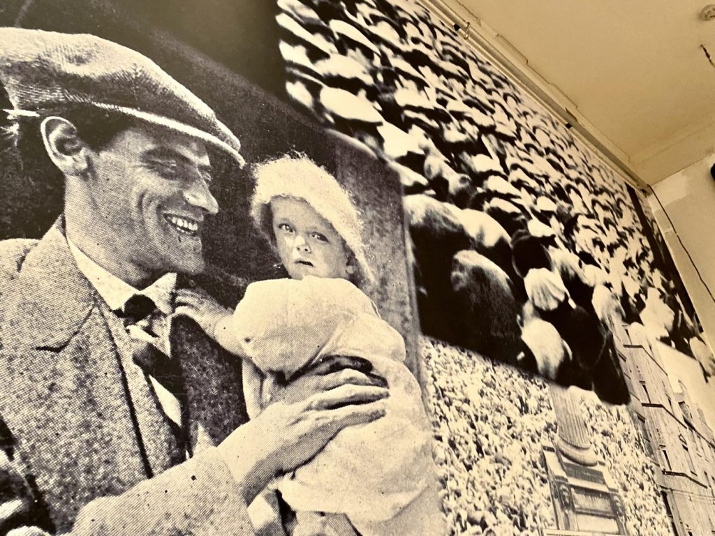 man in bunnet holding child